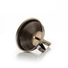 Bronze-colored metal tea infuser on a white background