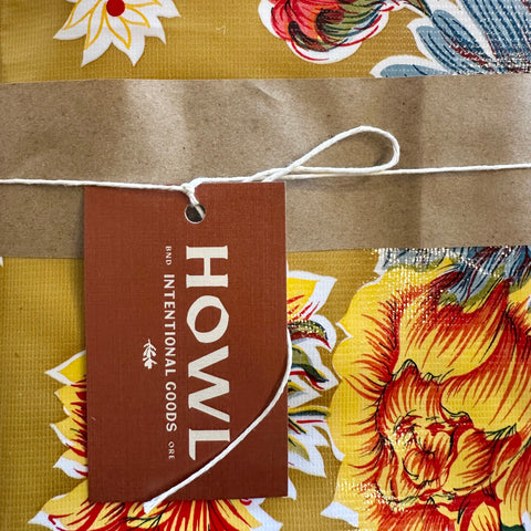 Floral fabric with a 'HOWL' tag on a brown background
