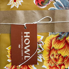 Floral fabric with a 'HOWL' tag on a brown background