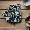 Patterned towels and bowls on a wooden surface