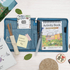 Children's activity book and stationery items on a white surface